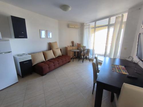a living room with a couch and a table at PSB Apartments in Midia Resort Aheloy in Aheloy