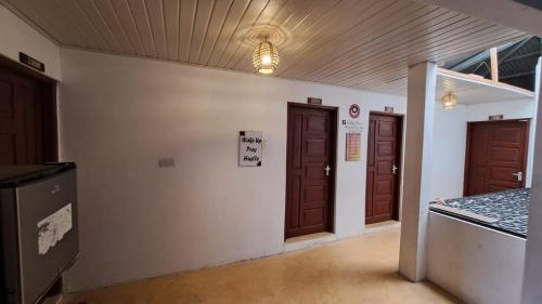an empty room with two doors and a wall at Roof Top House in Lamu