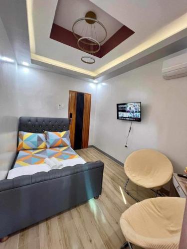 a living room with a bed and a table at Couple - Private Jacuzzi Pool in Mabalacat