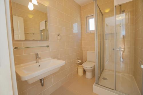 a bathroom with a sink and a toilet and a shower at Sunset Apartments with pool in Kalkan in Kalkan