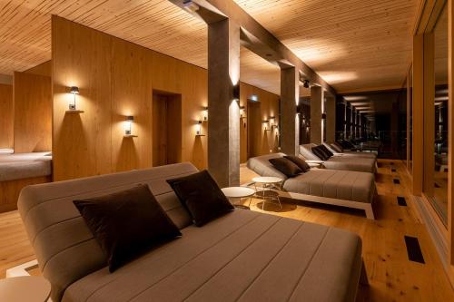 a living room with couches and tables in a building at Sackmann Genuss und Spa Resort in Baiersbronn