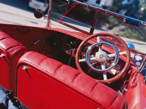 an interior view of a red car with a steering wheel at Sackmann Genuss und Spa Resort in Baiersbronn