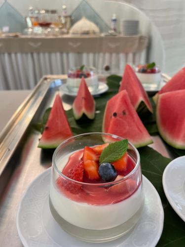 a dessert with fruit in a bowl on a plate at Villa Palmira Kinderfreies Hotel in Cannobio