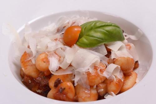 a bowl of food with shrimp with a green leaf on top at Hotel Berg in Staré Splavy