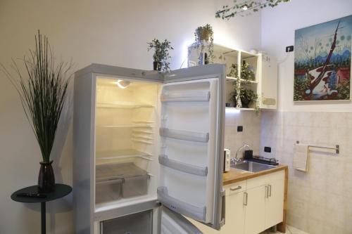 a refrigerator with its door open in a kitchen at Midnight blues for 3 people near the airport in Azzano San Paolo