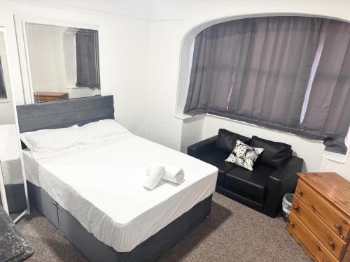 a small bedroom with a bed and a chair at Central 4 Bed House - Sleeps 8 & Free Parking in Southampton