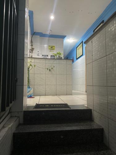 a bathroom with stairs in a room with tiles at Yellow house 1 in Salvador