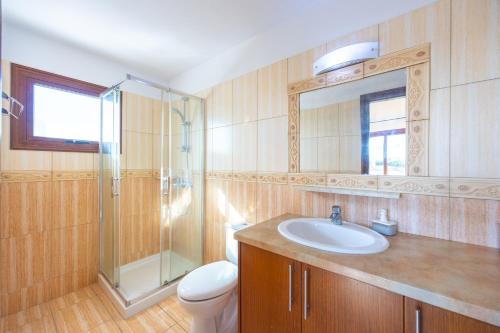 a bathroom with a sink and a shower and a toilet at Villa Sunlove in Peyia