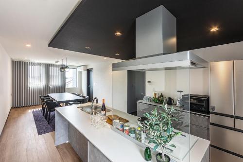 a kitchen and living room with a large counter top at Wonders Hotel in Hirabari