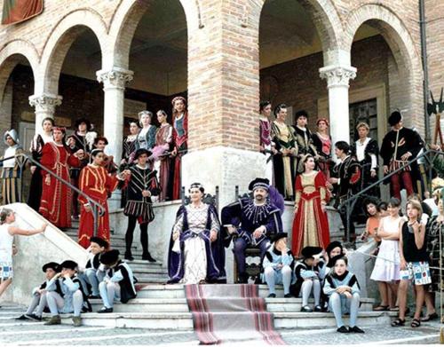a group of people sitting on steps in front of a building at Casa Vacanze Via Marconi in Marotta