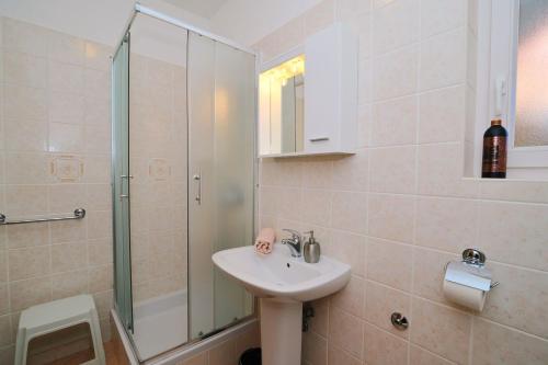 a bathroom with a sink and a shower at Blue Palm Apartment, Ika-Opatija in Ika