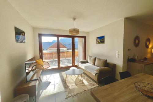 una sala de estar con un sofá y una mesa en T3 apartment with balcony in Briançon, en Briançon