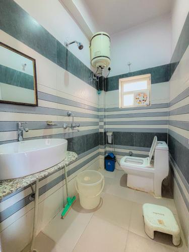 a bathroom with a sink and a toilet at Skyard Premium, Tapovan in Rishīkesh