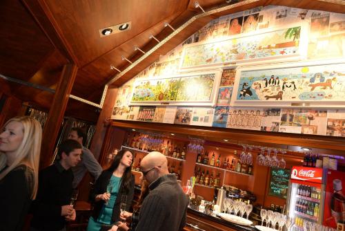 a group of people standing at a bar at Hotel Berg in Staré Splavy