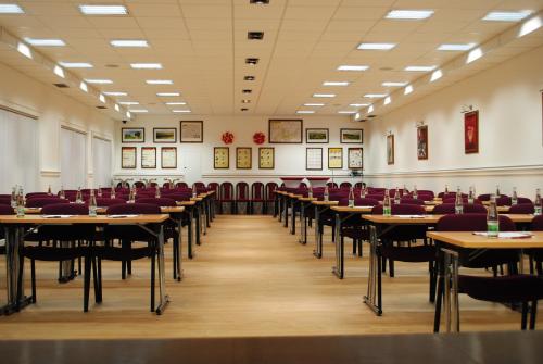 a large room with tables and chairs in it at Hotel Berg in Staré Splavy