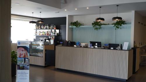 a bar in a restaurant with a counter and a refrigerator at Best Western Hotel Massafra in Massafra