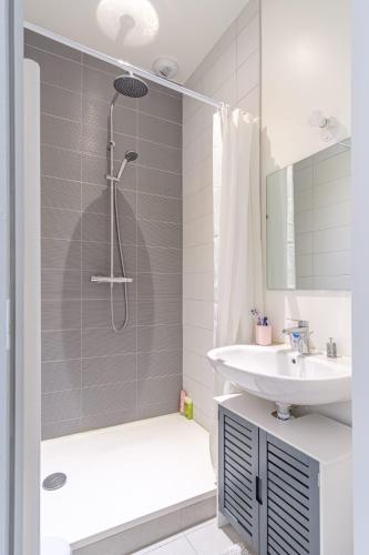 a white bathroom with a shower and a sink at Chambre dans colocation - Valence - in Valence