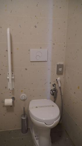 a bathroom with a toilet and a phone on the wall at Best Western Hotel Massafra in Massafra