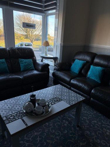 a living room with a couch and a coffee table at The Laurels Hotel in Skegness