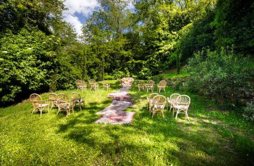 a group of tables and chairs in the grass at Villa Delia Hotel and Cooking School in Ripoli