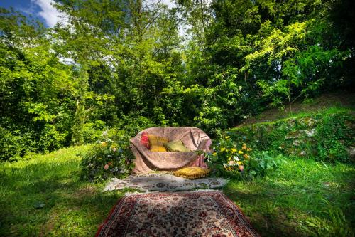 a chair sitting in the grass in a garden at Villa Delia Hotel and Cooking School in Ripoli