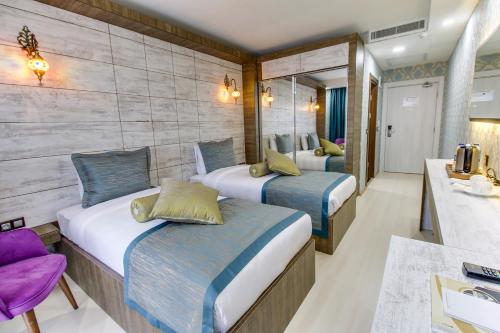 a hotel room with two beds and a bathroom at Elite World Nest Sivas in Sivas
