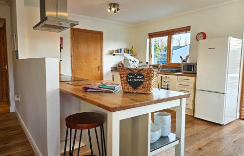 a kitchen with a counter and a white refrigerator at Lochside in Dornie