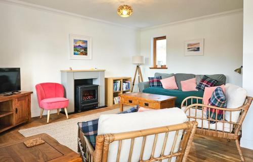 a living room with a couch and a tv at Lochside in Dornie