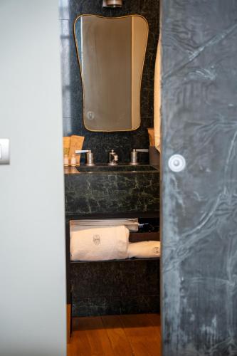 a bathroom with a sink and a mirror and towels at Club64 in Andria