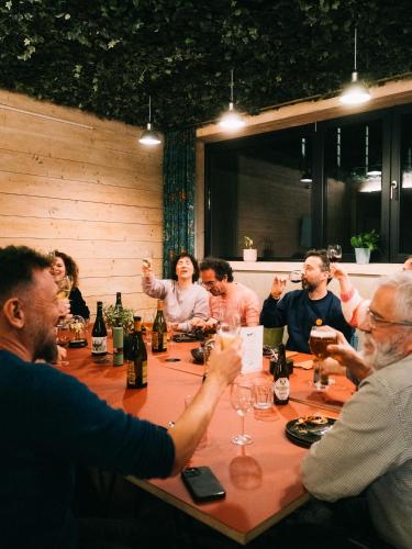 a group of people sitting around a table with wine glasses at Daft Hotel in Malmedy