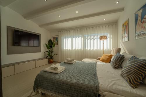 a bedroom with a large bed with towels on it at Tramonto A Nordovest in Favignana