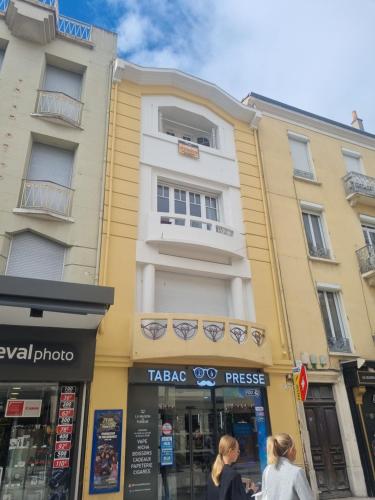 two women walking down a street in front of a building at Chambre dans colocation - Valence - in Valence