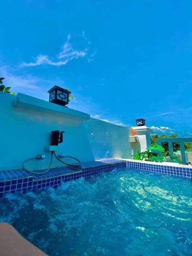 a swimming pool with a view of the ocean at Couple - Private Jacuzzi Pool in Mabalacat
