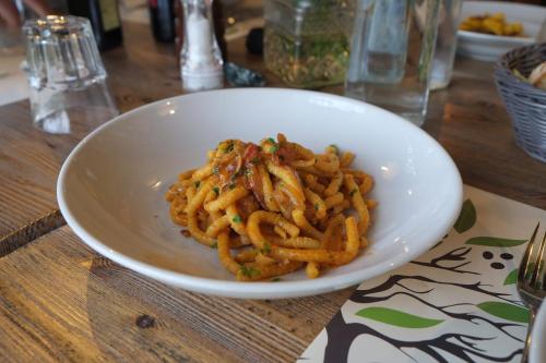 a white bowl of pasta on a table at Agriturismo La Rinaldina in Faenza
