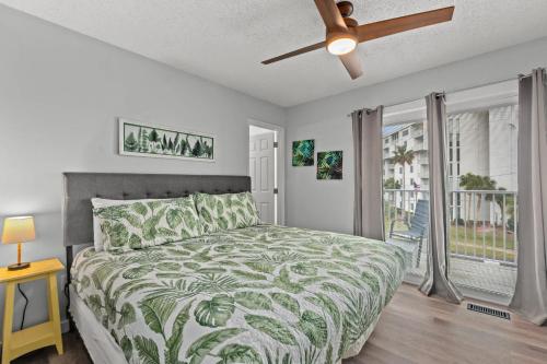 a bedroom with a bed and a ceiling fan at Bikini Bottom Destin Harbor Private Gated Beach in Destin