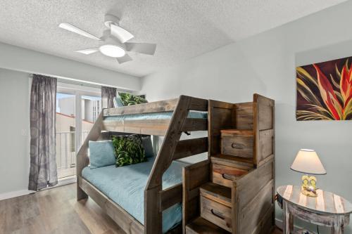 a bedroom with a bunk bed and a table at Bikini Bottom Destin Harbor Private Gated Beach in Destin