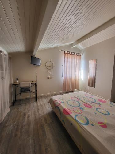 une chambre avec un grand lit et un bureau dans l'établissement Chambre ERREGUINA, à Hasparren