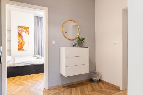 a bedroom with a white dresser and a mirror at Mirage Studio in Brno