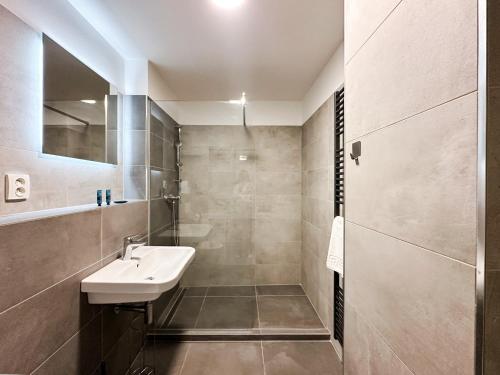 a bathroom with a sink and a shower at Mirage Studio in Brno