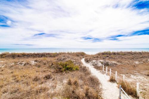 a path to the beach with the ocean in the background at Windy Waves Top Location w Pool in Myrtle Beach