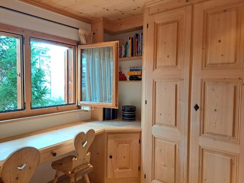 a home office with a desk and a window at Laax Chalet by Quokka 360 - Charming Chalet with private patio in Laax