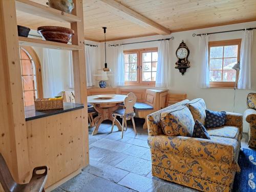 a living room with a couch and a table at Laax Chalet by Quokka 360 - Charming Chalet with private patio in Laax