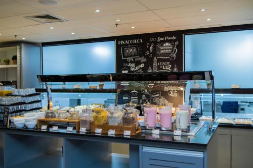a bakery with a counter with food in jars at B&B HOTEL São Paulo Luz - Centro in Sao Paulo