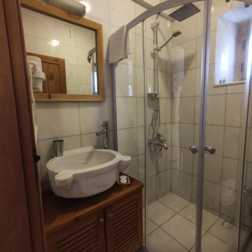 a bathroom with a sink and a shower at Eski Datca Evleri in Datca