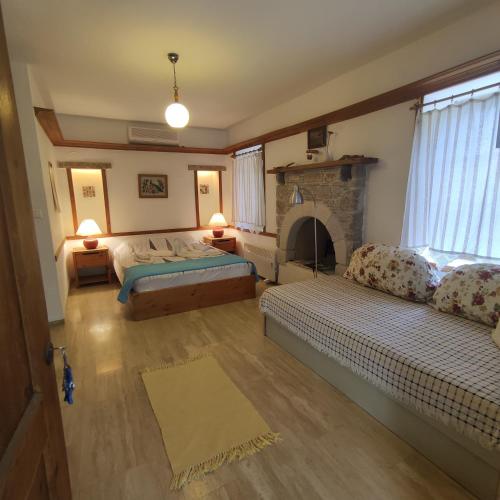 a living room with two beds and a fireplace at Eski Datca Evleri in Datca