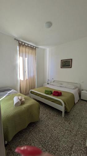 Postel nebo postele na pokoji v ubytování Casa Maddi Casa Vacanze con Vista Mare Vicinissima al Centro Capoliveri Isola d'Elba