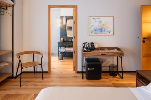 a bedroom with a desk and a chair and a table at Club64 in Andria