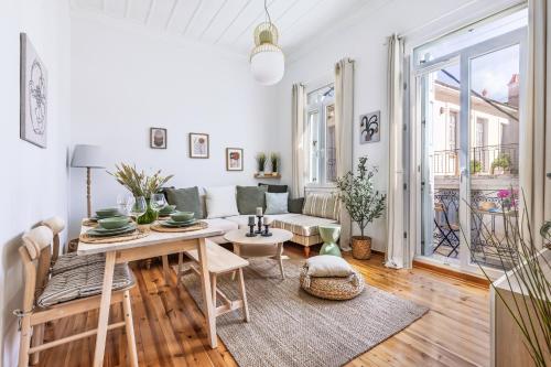 a living room with a table and a couch at Chora Residence in Skopelos Town