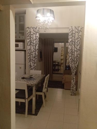 a kitchen and dining room with a table and chairs at Apartments in Bar city center in Bar