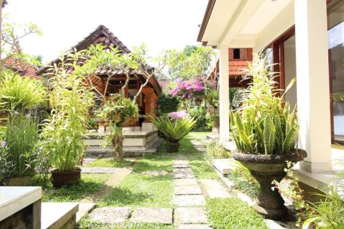 a garden in front of a house with plants at With Love Bali Homestay in Tegalalang